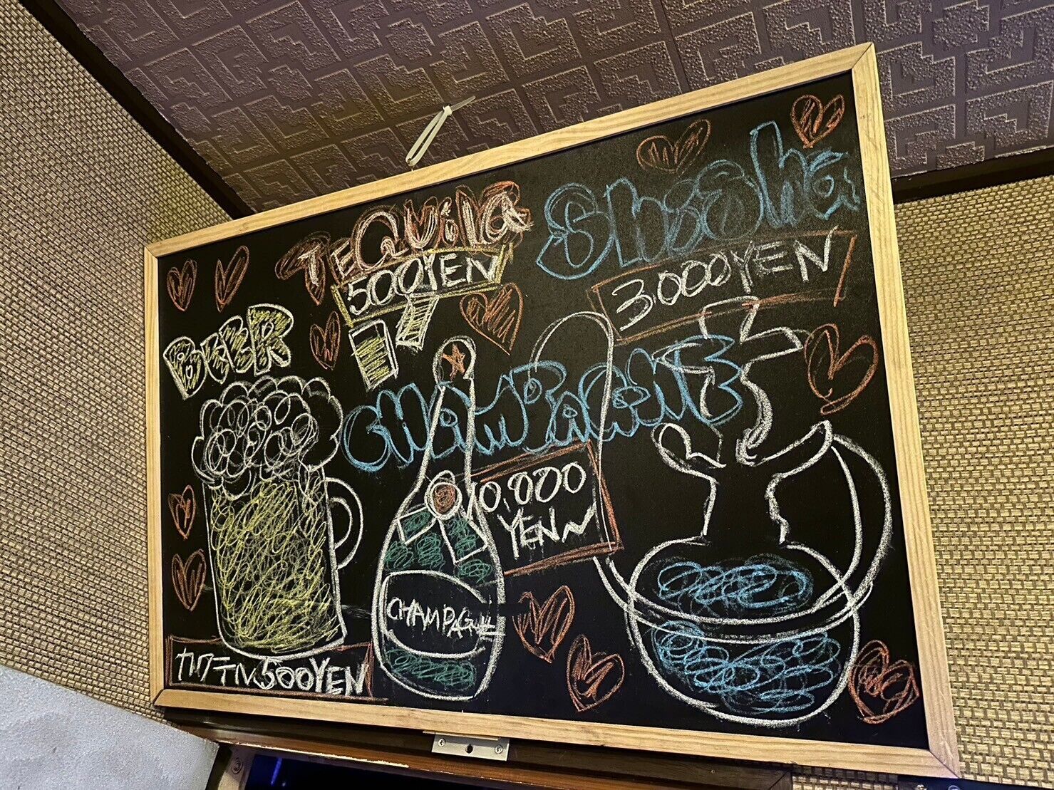 A chalkboard menu with various drink options and prices.