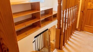 A wooden staircase with a handrail and a small skylight. - Lodge Road by Interhome (Inverness)