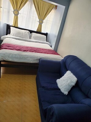 Relax in this inviting space with a comfortable bed and a cozy sofa.