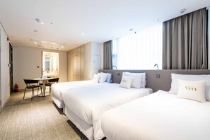 A hotel room with two beds, a desk, and a chair. - Hotel Vert (Seoul)