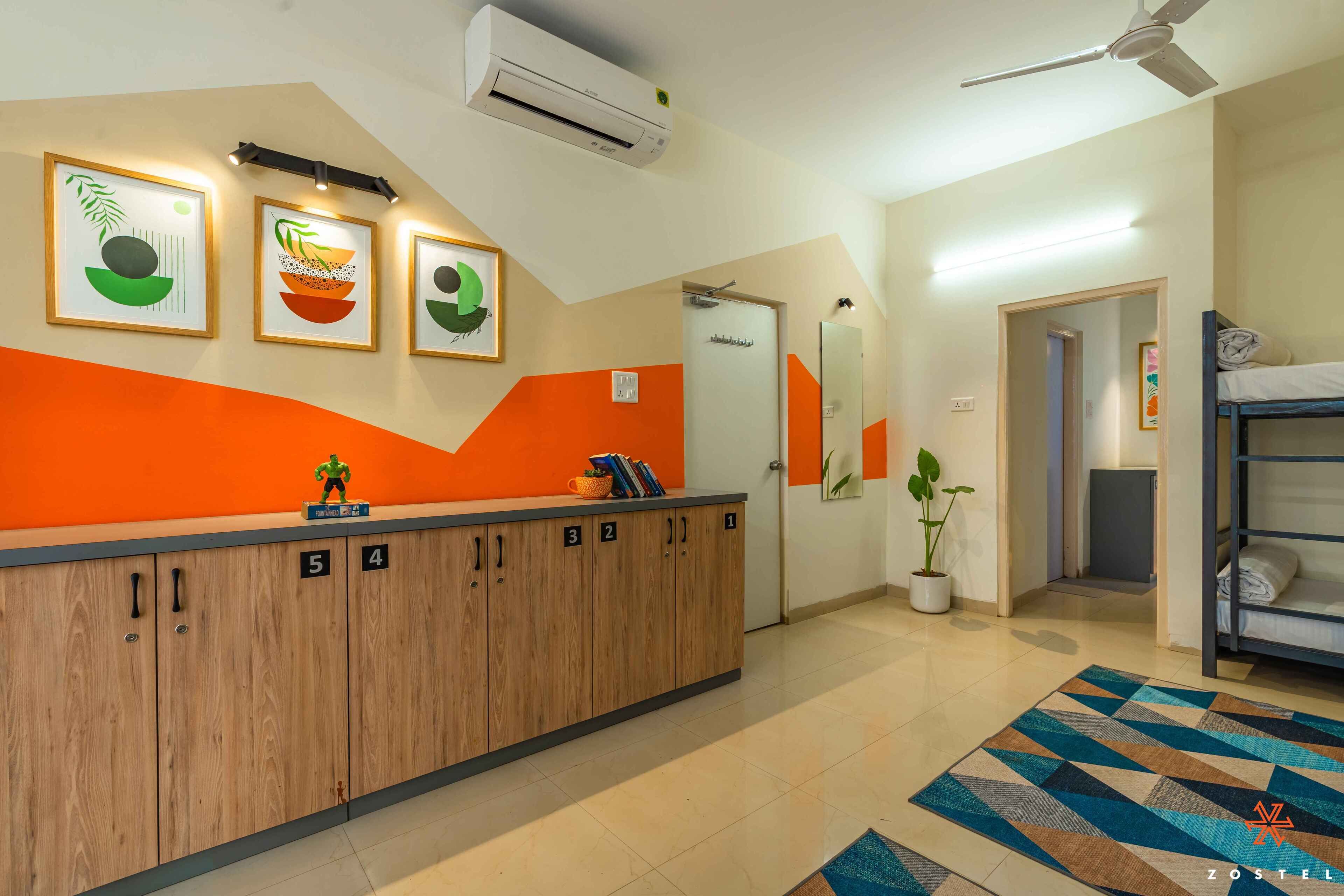 A hotel reception area with a wooden counter, numbered lockers, and a reception desk.