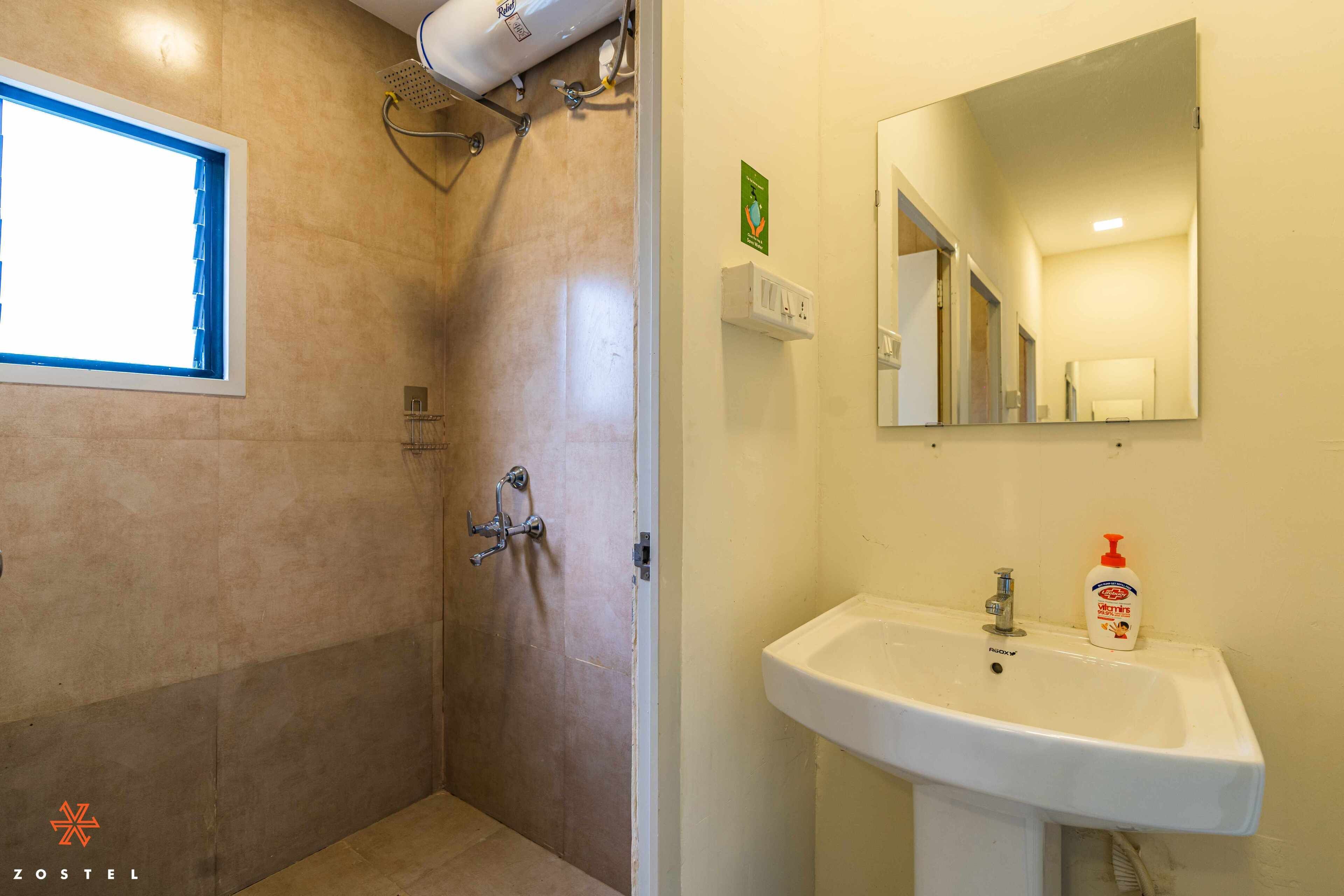 A bathroom with a shower, sink, and mirror.