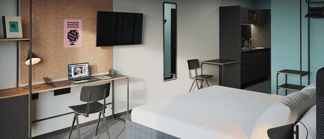 Una habitación de hotel moderna con cama, escritorio, silla y kitchenette.