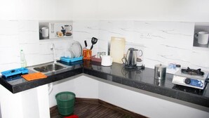 A compact kitchen with a sink, stove, and various utensils. - Beluga Sands Beach (Ambalangoda)