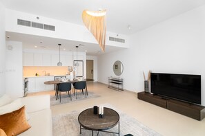 Elite Apartment | Living area | 55-inch Smart TV with cable channels - Nasma Holiday Homes - Creek Horizon Tower 1 (Dubai)