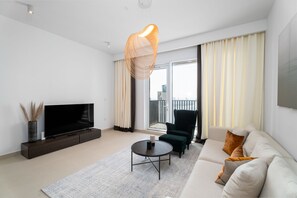 Elite Apartment | Living area | 55-inch Smart TV with cable channels - Nasma Holiday Homes - Creek Horizon Tower 1 (Dubai)