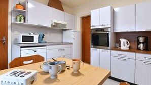 A compact kitchen with white cabinets, a microwave, a coffee maker, and a toaster. - Charming Home Between Colmar and Mulhouse, Near Wine Route and Europa-Park, Sleeps 6 (Oberentzen)