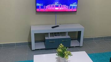 Business Apartment | Living area | 24-inch Smart TV with digital channels