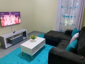 Business Apartment | Living area | 24-inch Smart TV with digital channels