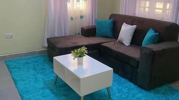 Business Apartment | Living area | 24-inch Smart TV with digital channels