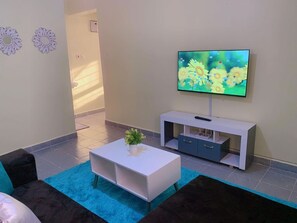 Business Apartment | Living area | 24-inch Smart TV with digital channels