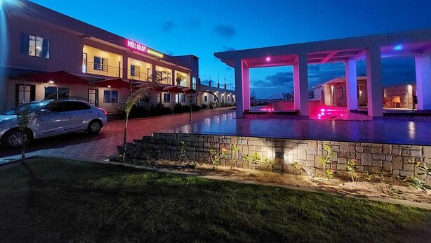 A hotel with a modern design, featuring a well-lit entrance and a covered outdoor area. - Sea Wave Beach Resort (Kanthi)