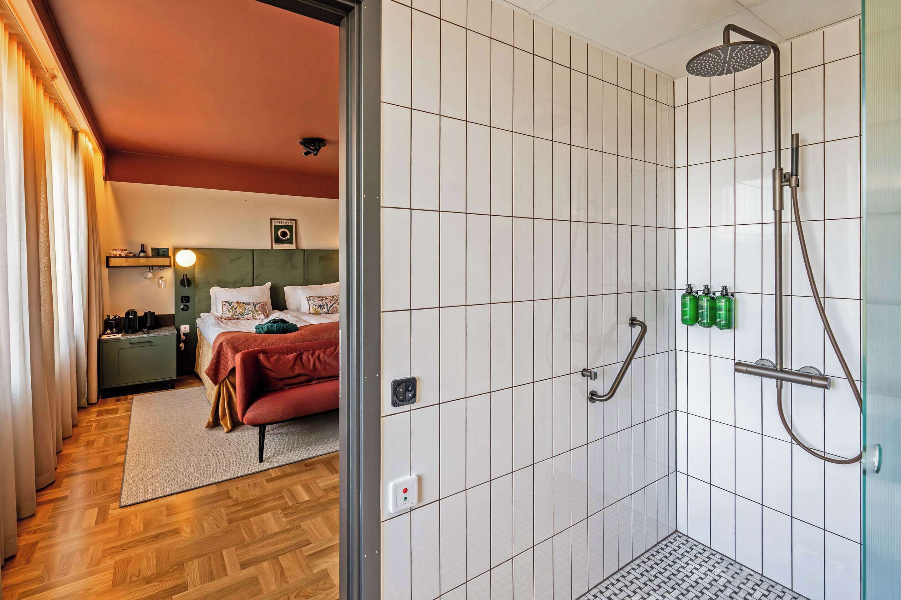 A modern bathroom with a shower, toilet, and sink.
