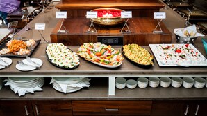A buffet with various dishes labeled, including egg omelet, green salad, and parsley potato salad. - HOTEL LUCKY INDIA  (Bhubaneshwar)
