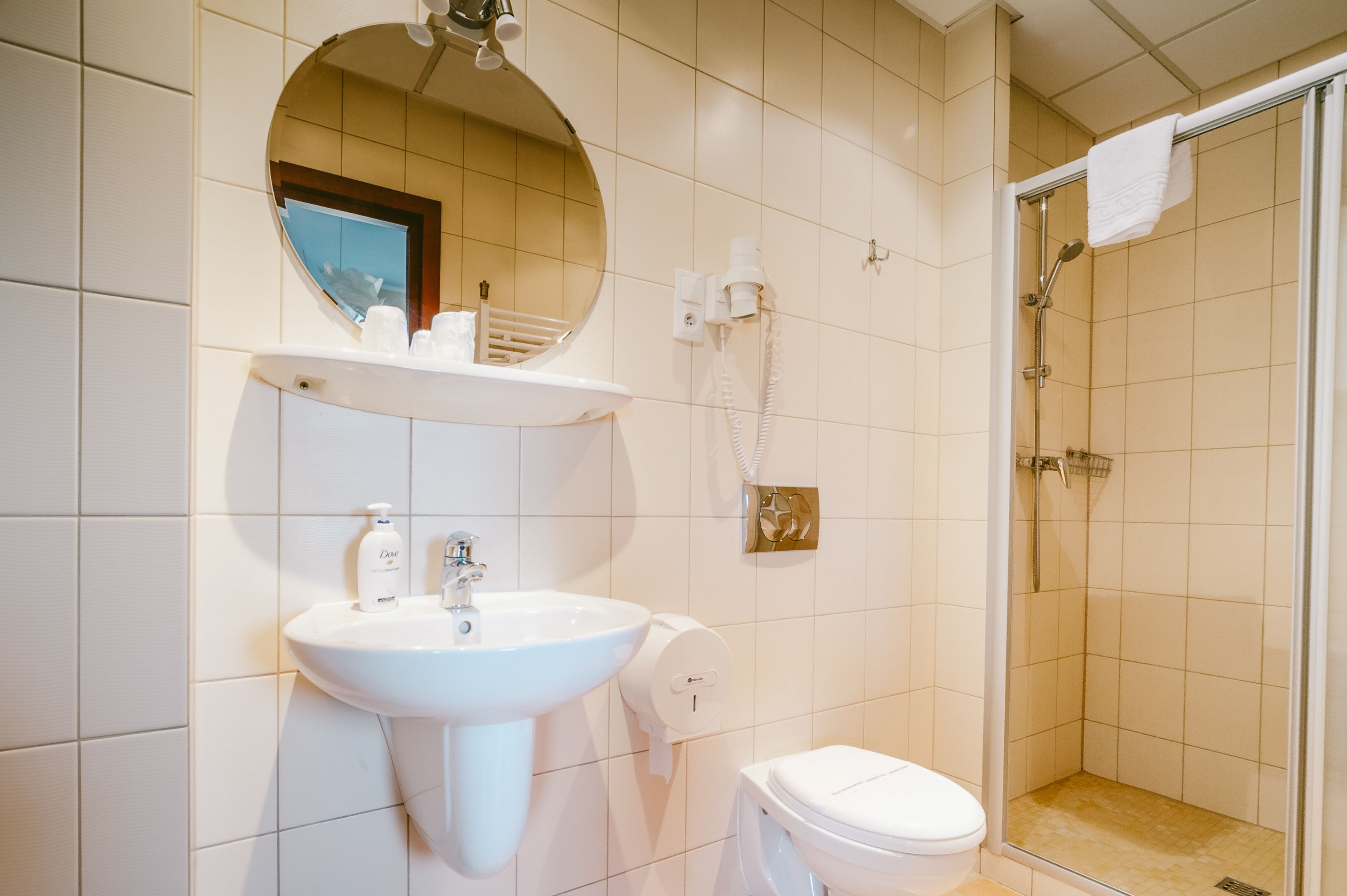 Ein Badezimmer mit Waschbecken, Spiegel und Toilette.