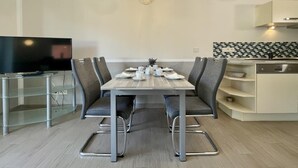 A modern kitchen with a dining area. - Amselresidenz 1 - AMSEL (Binz)