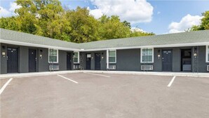A building with a parking lot and a covered outdoor area. - Whimsical 2BR 10-Mins to Nashville (Nashville)