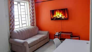Deluxe Apartment | Living area | 24-inch Smart TV with digital channels