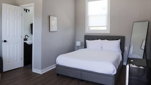 A bedroom with a bed, a window, a door, a sink, and a mirror. - Peaceful 1BR Apt 10-Mins to Nashville (Nashville)