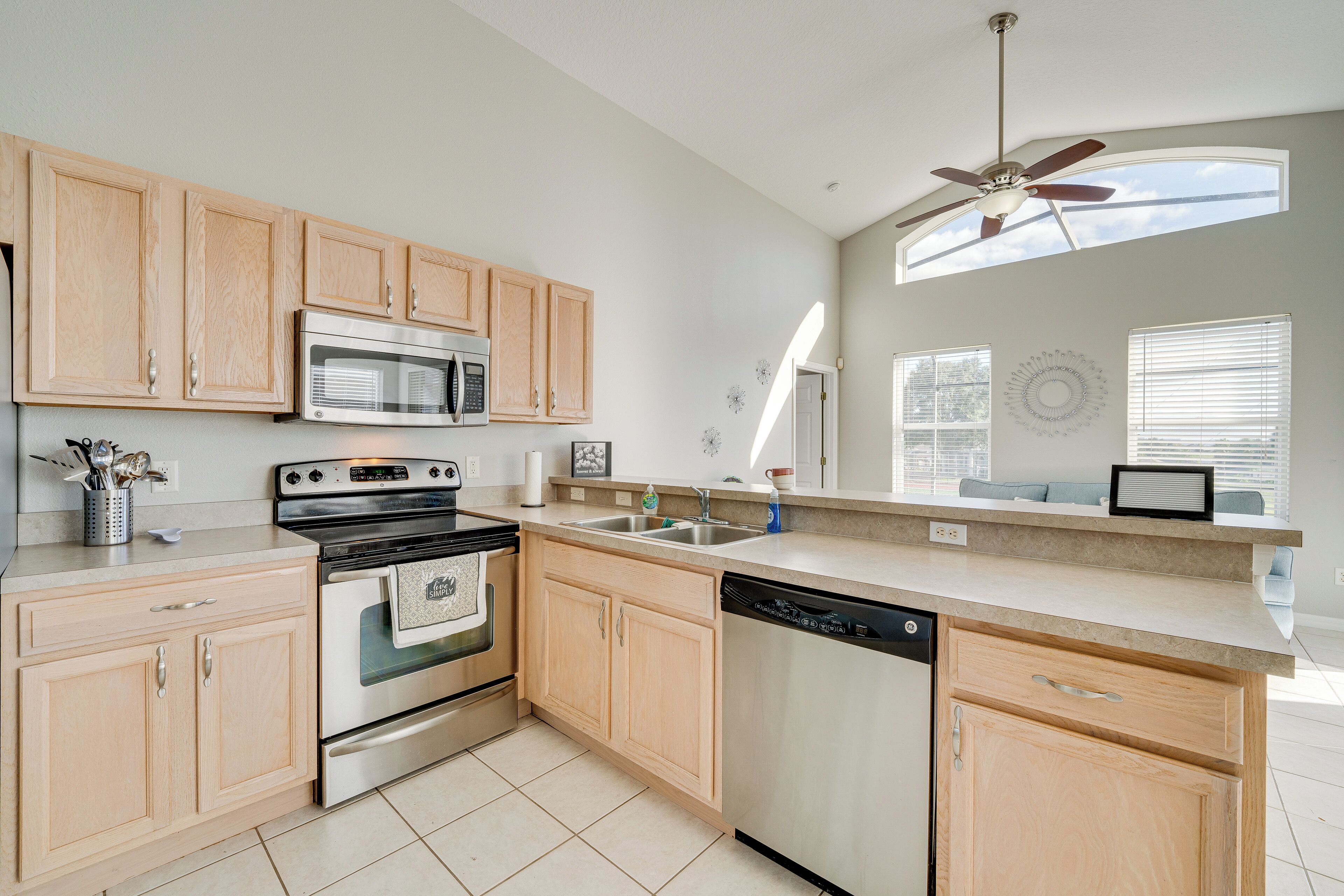 A kitchen with wooden cabinets, stainless steel appliances, and a dishwasher.