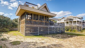 A beachfront house with a large balcony, multiple levels, and a wooden deck. - Kitty Hawk Vacation Rental w/ Private Pool! (Kitty Hawk)