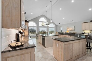 Enjoy cooking in this well-designed kitchen with a large island, ample counter space, and integrated appliances.