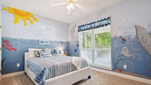 A bedroom with a bed, a ceiling fan, and a window with curtains. - Stay like a local in this pet-friendly home with private pool!  (Dauphin Island)