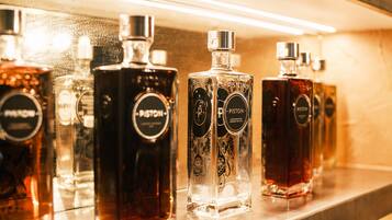 A row of glass bottles with labels on a shelf.