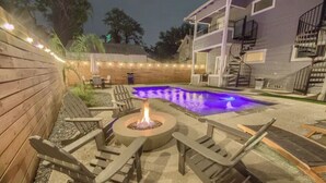 A backyard with a fire pit, lounge chairs, and a swimming pool. - The Monty #2- Luxury,Downtown, near the River Walk (San Antonio)