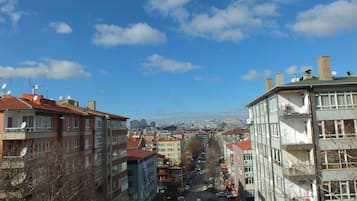 A cityscape with buildings, a street, and a clear sky.