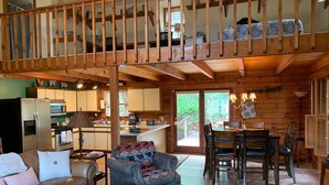 A cozy cabin interior with a dining area, kitchen, and living room. - Cozy Mtn Log Cabin, wonderful views, 5 mins from Hayesville town sq, sleeps 8. (Hayesville)