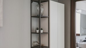 A modern kitchen with a wooden countertop, a built-in white cabinet, and a black shelving unit with glass containers and small plants. - San Pietro Cozy And Quiet Three-room Apt (Rome)