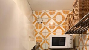 A compact kitchen with a microwave, a built-in oven, and a sink. - Stunning 1-bed Apartment in Oostende Beach-view (Ostend)