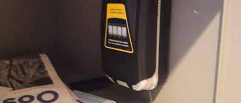 A shelf with a black object, possibly a phone, and a white item with '500' visible.