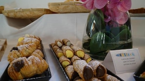 A display of pastries including croissants and cannoli on a table. - Life Hotels Des Alpes (Folgaria)