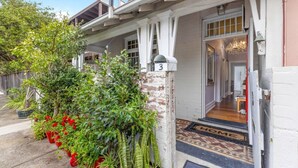 A house with a porch, a mailbox, and a door leading inside. - Peaceful & Light Paddington home (Paddington)