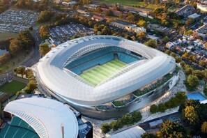 An aerial view of a stadium with a large central field, surrounded by parking lots and residential buildings. - Peaceful & Light Paddington home (Paddington)