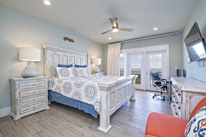 A bedroom with a large bed, two bedside tables, a desk, and a chair. - Lemonshello BeachFront, Hot tub, Heated Pool, 8 bedrooms (Gulf Shores)