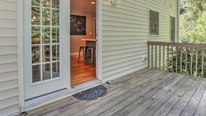 A wooden deck with a sliding glass door leading to an interior space with a bar area and a chalkboard wall. - Best of the Blue Ridge by Avantstay A+ Location (Arden)