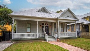 A two-story house with a front porch, a covered entryway, and a small front yard.