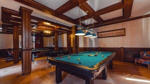 A pool table in a room with wooden beams and a billiards table in the background. - Chateau Kvirike (Kobuleti)