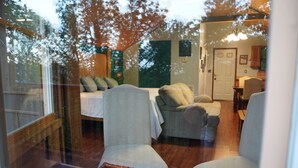 A living room with a sofa, two armchairs, and a dining table. - Peaceful Smoky Mountain Cabin Near Cades Cove (Townsend)