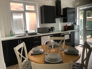 Enjoy meals in this kitchen with a central island, sink, microwave, coffee maker, and dishwasher.