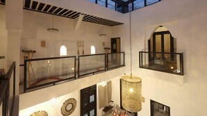 A spacious interior with a high ceiling, a glass roof, and a mezzanine level. - Riad Modern bed & breakfast  (Marrakech)