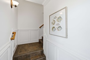 A staircase with white walls and a framed fish illustration. - Private Pool Beach Front Sleeps 18 Family home (St, George Island)