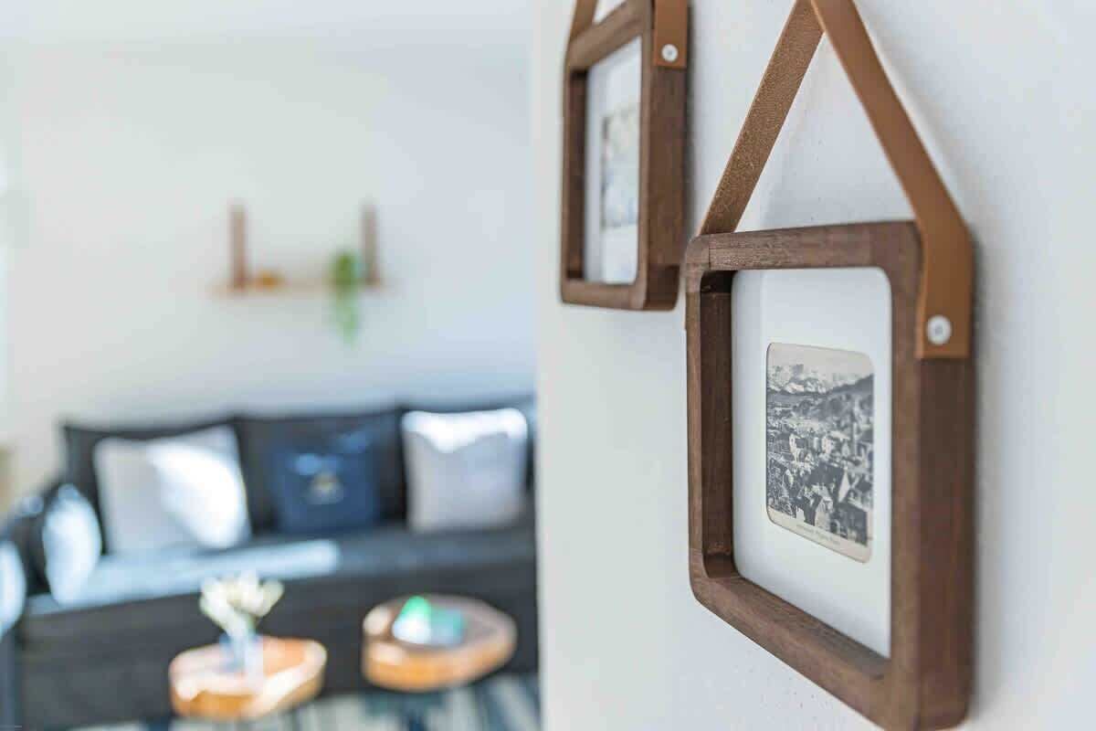 A framed picture hanging on a wall with a simple, modern design.