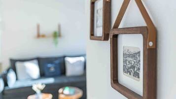 A framed picture hanging on a wall with a simple, modern design.