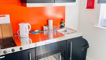 Fridge, microwave, stovetop, dining tables