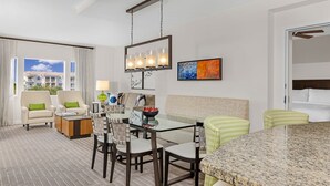 A hotel room with a dining area, a sofa, a coffee table, and a view of the outside. - Marriott Grande Vista Spacious 1-Bedroom Villa Dec. 26, 2023 - Jan. 2, 2024. (Orlando)