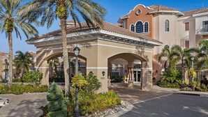 A hotel entrance with a covered patio, palm trees, and a well-maintained garden. - Marriott Grande Vista Spacious 1-Bedroom Villa Dec. 26, 2023 - Jan. 2, 2024. (Orlando)